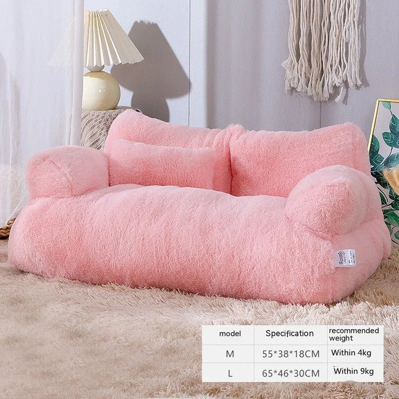 Pink fluffy pet bed on a carpeted floor with a lamp and decorative items in the background.